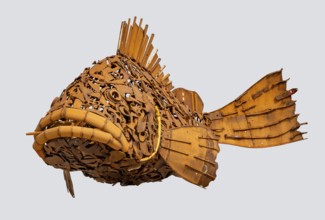 Rusty fish sculpture isolated in light back