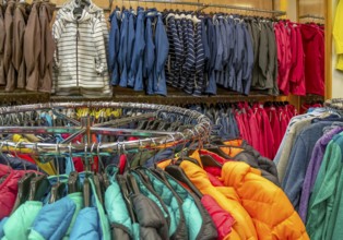 Picture showing lots of colorful clothing hanging in a store