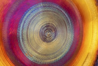 Full frame abstract detail shot of a colorful metallic gong