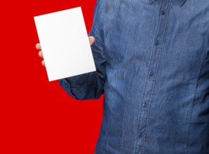 Male person holding a white blank sign in red back