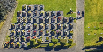 Aerial view, Langenei cemetery with colourful flower grave field, two visitors, shapes and colours,