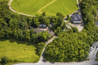 Aerial view, open-air stage covered by trees and adjacent buildings with towers, right playhouse of