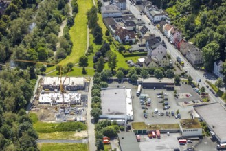 Aerial view, construction site with new building next to the fire brigade fire station on the river
