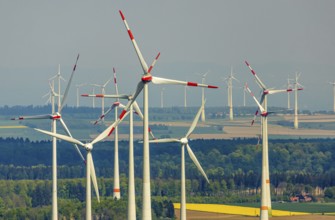 Aerial view, wind park and wind farm wind energy plant, wind turbines and rape fields near