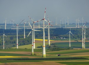 Aerial view, wind park and wind farm wind energy plant, wind turbines and rape fields near