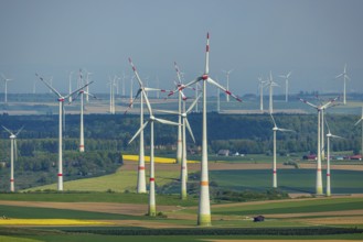 Aerial view, wind park and wind farm wind energy plant, wind turbines and rape fields near