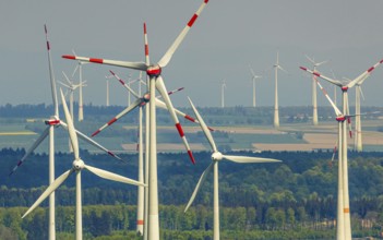 Aerial view, wind park and wind farm wind energy plant, wind turbines and rape fields near