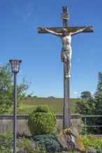 Crucifix and lantern at the Roman Catholic parish church of the Assumption of the Virgin Mary in