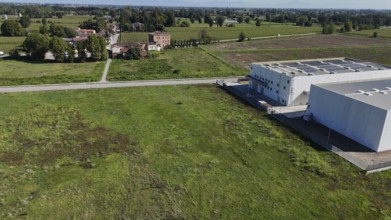 Modern industrial facility development in the Italian countryside showcasing infrastructure growth