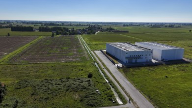 Modern data center facility situated in a rural landscape of Lombardy Italy surrounded by