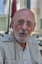 Elderly gentleman with beard and glasses, doubtful look, Dornbirn, Vorarlberg, Austria