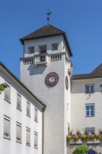 Light grey façade with tower, clock and floral decorations, Dornbirn, Vorarlberg, Austria