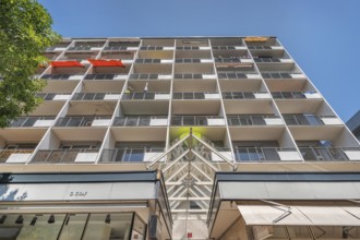 Concrete building with balconies and red awnings, Dornbirn, Vorarlberg, Austria