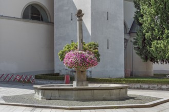 St Martin's Fountain with floral decorations at the parish church of St Martin, Dornbirn,