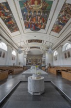 The Roman Catholic parish church of St Martin, interior with altar, ceiling frescoes and baptismal