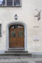 Façade with wooden gate, lantern and ivy wreaths, former residence of the patrician Vogt family,