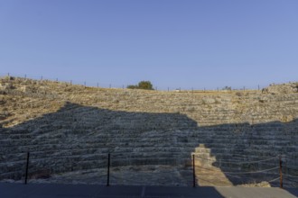 08/21/2025 ronda, malaga, spain Stone steps of a roman theater bask in the sunlight under a vibrant