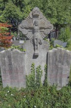 Gravesite with stone crucifix and ivy, catholic cemetery, Kempten, Allgäu, Bavaria, Germany