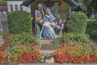 Gravesite with depiction of the Descent from the Cross and floral decoration, Catholic cemetery,