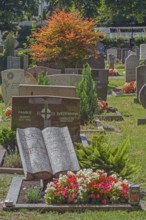 Gravesite with stone book and floral decoration, catholic cemetery, Kempten, Allgäu, Bavaria,