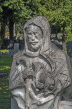 Gravesite with stone figure, the good shepherd with lamb catholic cemetery, Kempten, Allgäu,