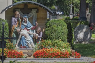 Gravesite with depiction of the Descent from the Cross and floral decoration, Catholic cemetery,