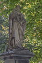 Gravesite with weathered figure of Christ blessing, catholic cemetery, Kempten, Allgäu, Bavaria,