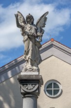The angel on the fountain column by the funeral parlour, Catholic cemetery, Kempten, Allgäu,