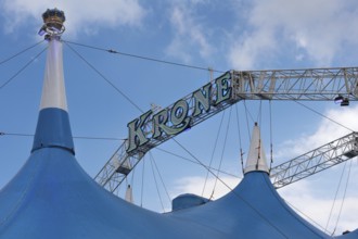 Circus tent, circus tent with large luminous lettering in front of a blue sky, Circus-Krone,