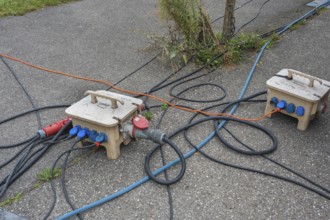 Power cable and power distributor on asphalt, Circus-Krone, Kempten, Allgäu, Bavaria, Germany