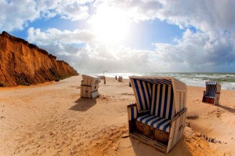 Beach with beach chairs at the Red Cliff near Kampen on Sylt on the North Sea at sunset