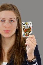 Woman holding a playing card in her hand