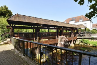 Ettlingen, Germany - August 13th 2025: Old wooden bridge over the Alb river. Historic landmark on a