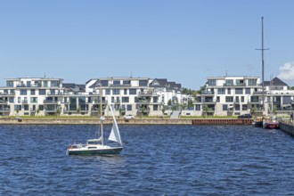 Residential area on the eastern bank of the Unterwarnow, sailing boat, Rostock,