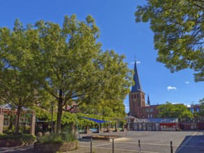 Old town with catholic church St. Margareta, brick building, architecture, square with sandpit,