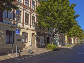 Street in the old town, trees, car park for scooters, e-scooters, blue sky, sunshine, Brühl, North