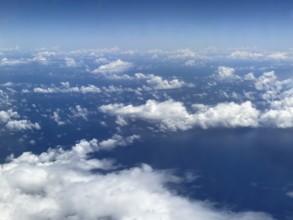 Aerial view from aeroplane at high altitude of white, bright cluster clouds Altocumulus,