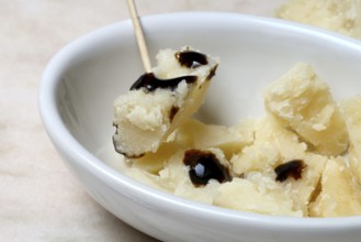 Parmesan cheese, pieces of cheese with crema di balsamico in small bowls