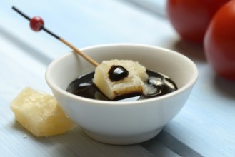 Parmesan cheese, pieces of cheese with crema di balsamico in small bowls