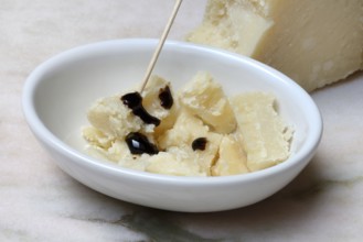 Parmesan cheese, pieces of cheese with crema di balsamico in small bowls