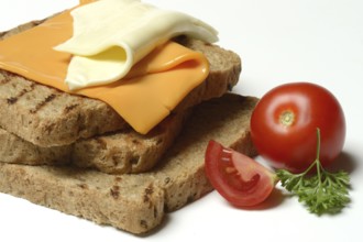 Processed cheese, slices of processed cheese on toast and tomato