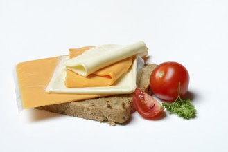 Processed cheese, slices of processed cheese on toast and tomato