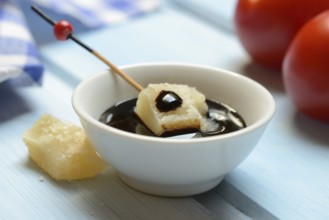 Parmesan cheese, pieces of cheese with crema di balsamico in small bowls