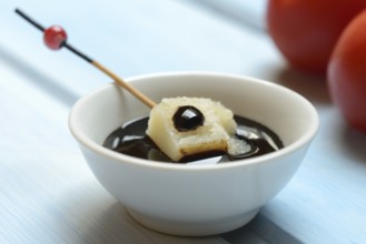 Parmesan cheese, pieces of cheese with crema di balsamico in small bowls