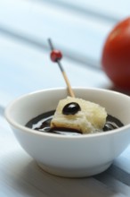 Parmesan cheese, pieces of cheese with crema di balsamico in small bowls