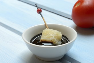 Parmesan cheese, pieces of cheese with crema di balsamico in small bowls