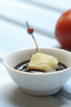 Parmesan cheese, pieces of cheese with crema di balsamico in small bowls