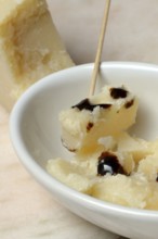 Parmesan cheese, pieces of cheese with crema di balsamico in small bowls