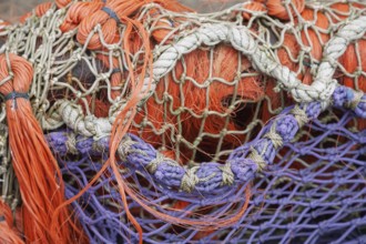 Close-up of superimposed, colourful fishing nets in orange and purple, East Frisia, Lower Saxony,
