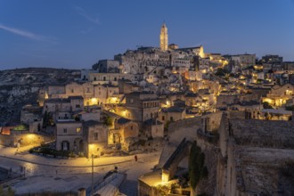 City view of Matera with the Sassi cave settlements and the cathedral at dusk, Matera, Basilicata,